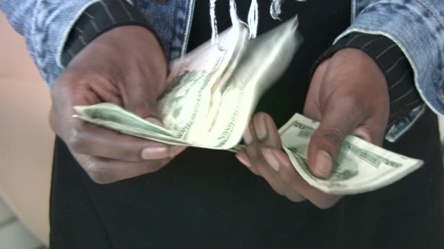 African-american man male counting dollar bills by hands.